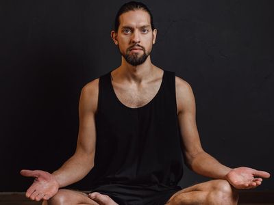 Close up of a yoga mat on a dark floor.