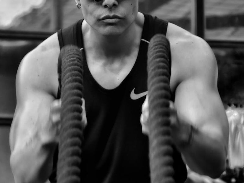 Person performing a slow mobility movement in a gym.